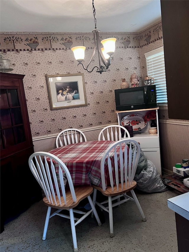 dining space featuring a notable chandelier