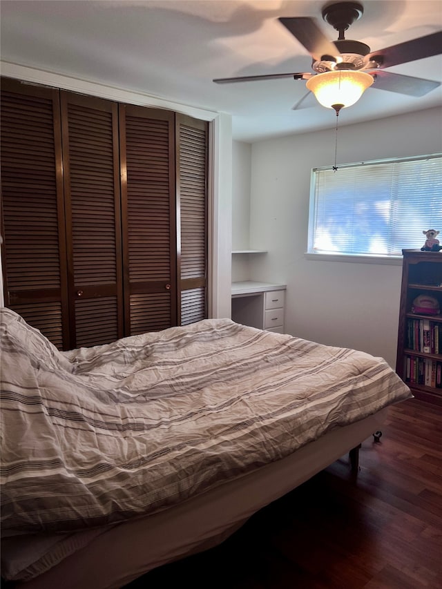 bedroom featuring a closet, ceiling fan, and dark wood-type flooring