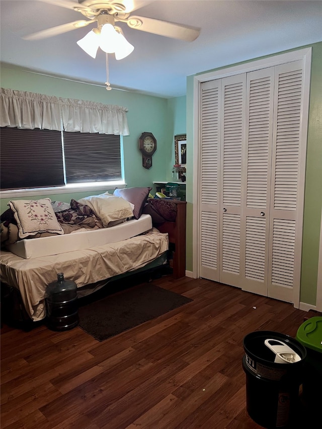 bedroom featuring a closet, dark hardwood / wood-style floors, and ceiling fan