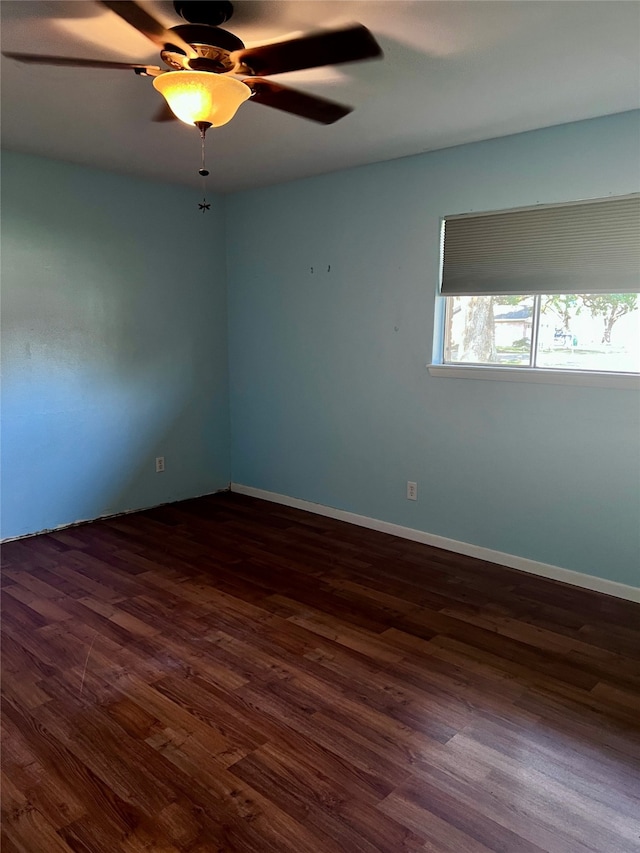 spare room featuring ceiling fan and dark hardwood / wood-style floors