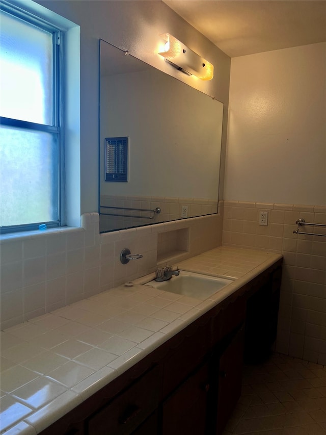 bathroom with tile patterned floors, vanity, and tile walls