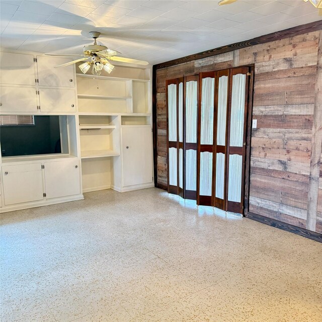 unfurnished living room with ceiling fan