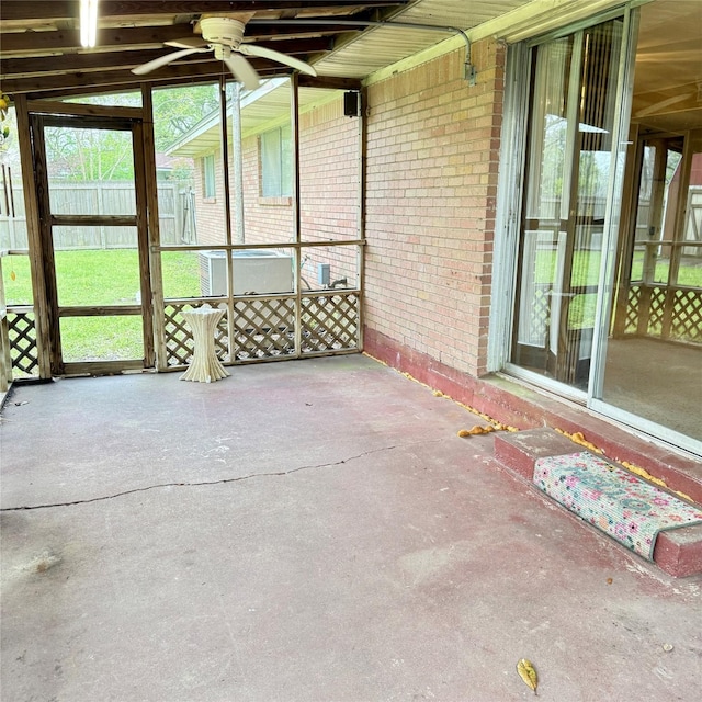 unfurnished sunroom with a ceiling fan
