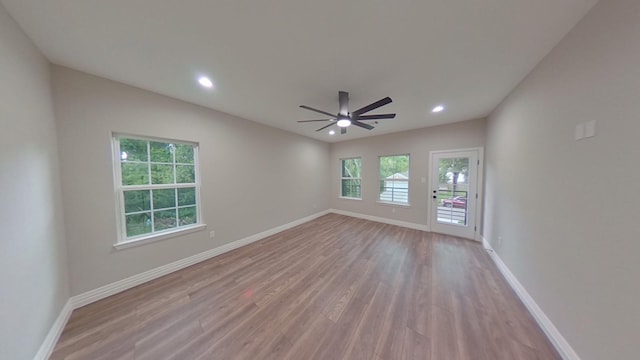 empty room with light hardwood / wood-style flooring and ceiling fan