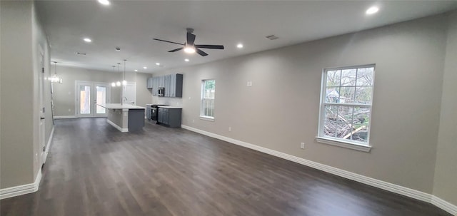 unfurnished living room featuring sink, french doors, ceiling fan, and dark hardwood / wood-style flooring