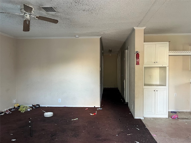 unfurnished room with ornamental molding, a textured ceiling, and ceiling fan