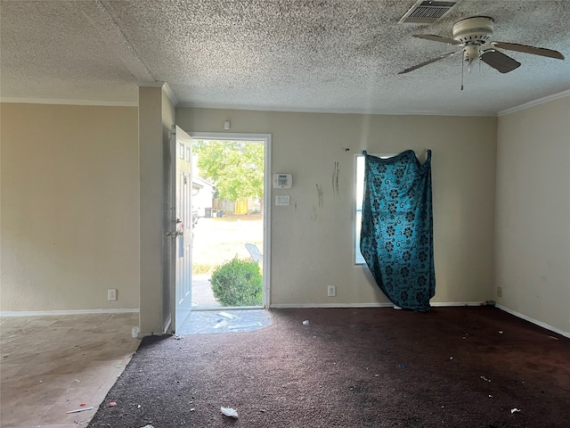 carpeted entryway with ornamental molding, a textured ceiling, and ceiling fan