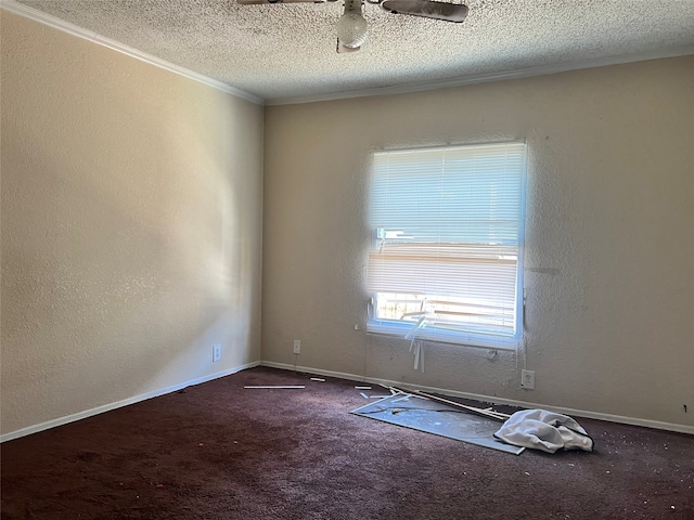 carpeted empty room featuring ornamental molding and a textured ceiling