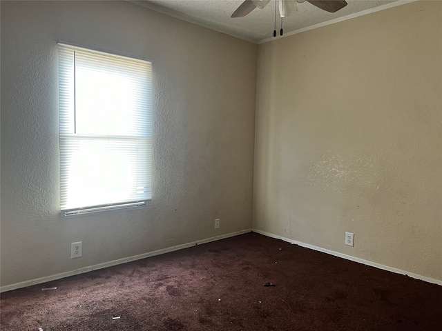 carpeted empty room with ceiling fan, ornamental molding, and a textured ceiling