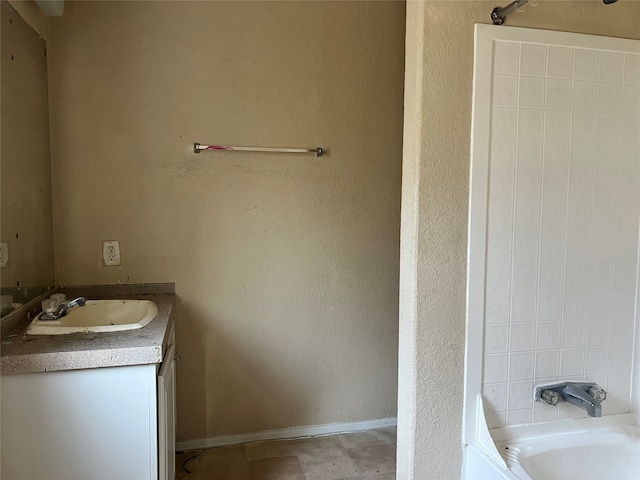 bathroom with vanity and a tub to relax in