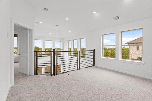 carpeted spare room with a healthy amount of sunlight