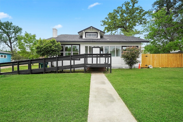 rear view of property with a deck and a lawn