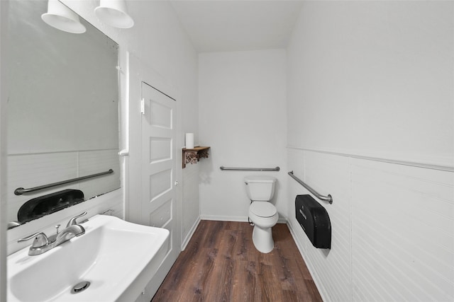 bathroom featuring hardwood / wood-style flooring, sink, and toilet