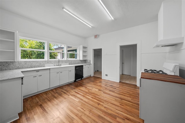 kitchen featuring white cabinetry, sink, white gas range oven, light hardwood / wood-style flooring, and black dishwasher