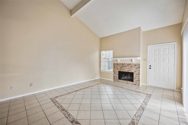 unfurnished living room featuring light tile patterned flooring, a textured ceiling, a tile fireplace, beam ceiling, and high vaulted ceiling