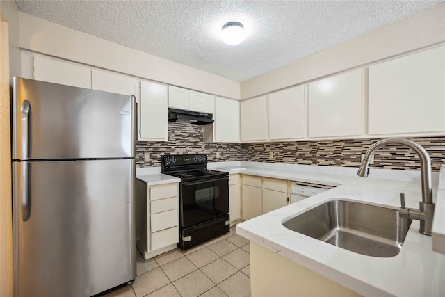 kitchen with black electric range oven, white cabinets, backsplash, stainless steel refrigerator, and sink