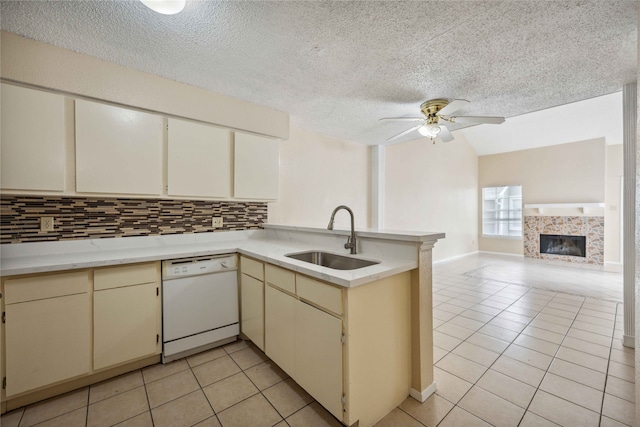 kitchen featuring sink, dishwasher, kitchen peninsula, and cream cabinets