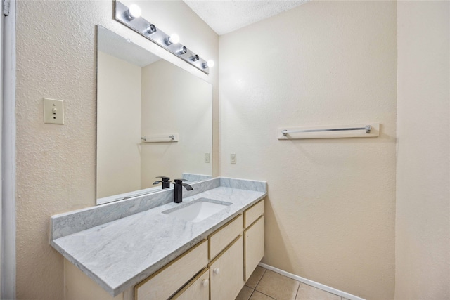 bathroom with vanity, tile patterned floors, and a textured ceiling