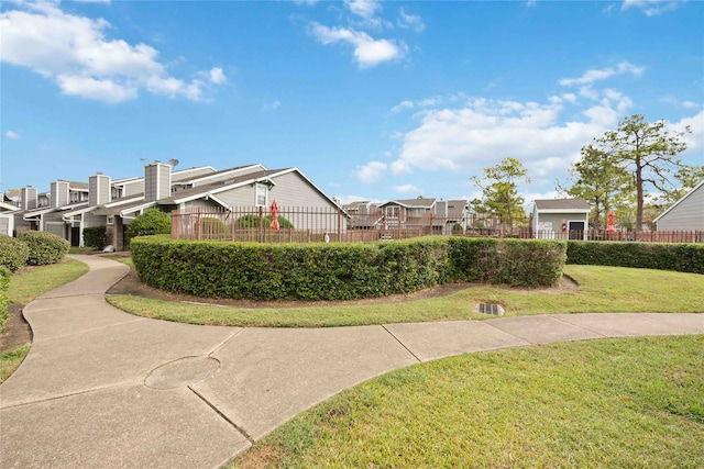 view of home's community with a yard