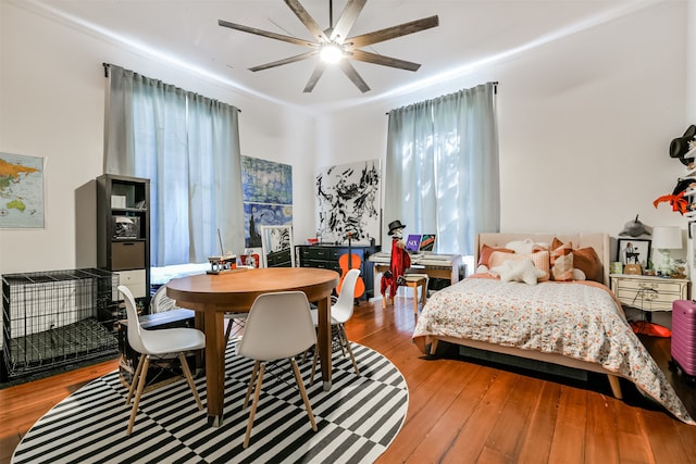 bedroom featuring ornamental molding, wood-type flooring, and ceiling fan