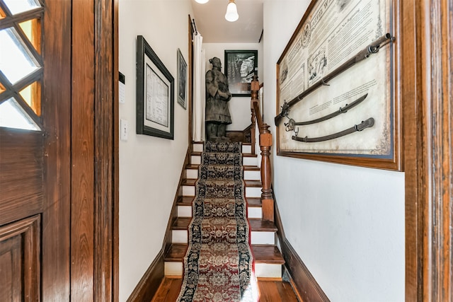 stairs with hardwood / wood-style flooring