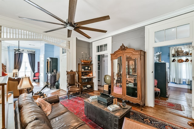 living room featuring crown molding, hardwood / wood-style flooring, and ceiling fan