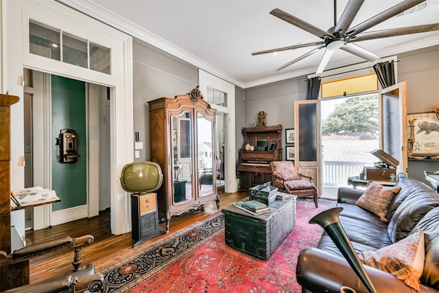 interior space featuring hardwood / wood-style floors, crown molding, and ceiling fan