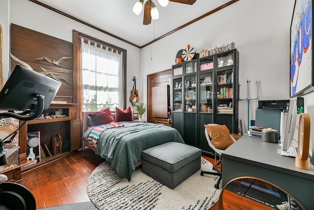 bedroom featuring ceiling fan, crown molding, and dark hardwood / wood-style floors