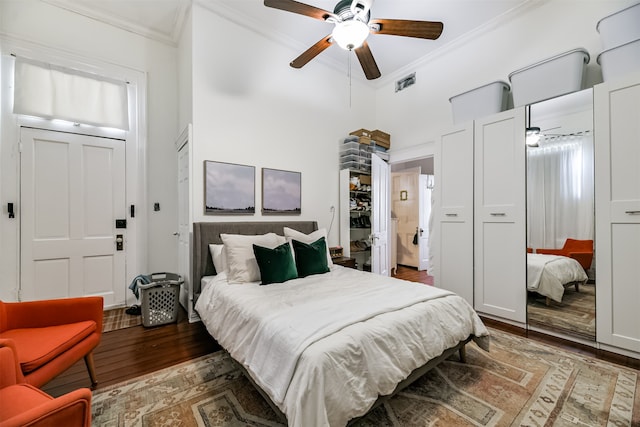 bedroom featuring crown molding, ceiling fan, and dark hardwood / wood-style flooring