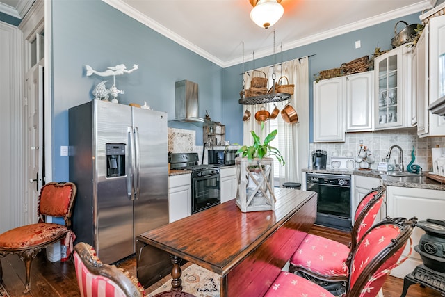 kitchen with black appliances, sink, wood-type flooring, white cabinetry, and wall chimney exhaust hood