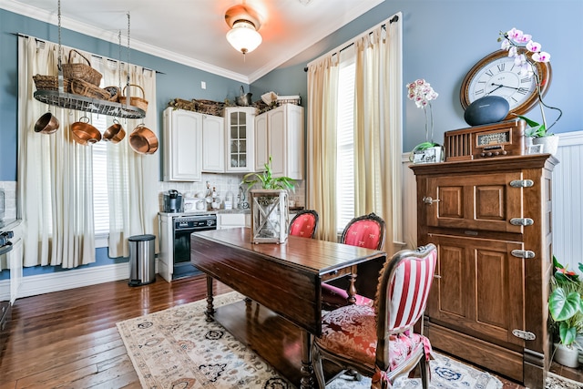 dining space featuring dark wood-type flooring and ornamental molding