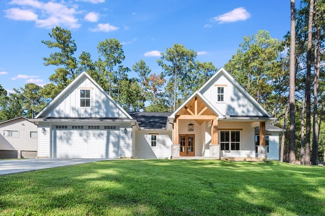 modern farmhouse style home featuring covered porch, a front yard, and a garage