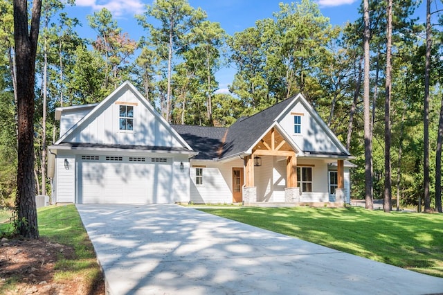 view of front facade with a porch, a front yard, and a garage