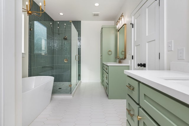 bathroom featuring vanity, a chandelier, separate shower and tub, and tile patterned flooring