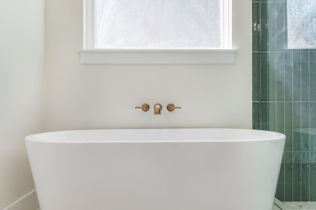 bathroom with a tub to relax in