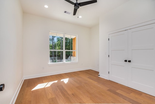 unfurnished room with light wood-type flooring and ceiling fan