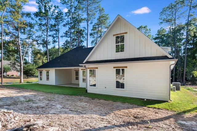 rear view of property featuring a patio area and a lawn