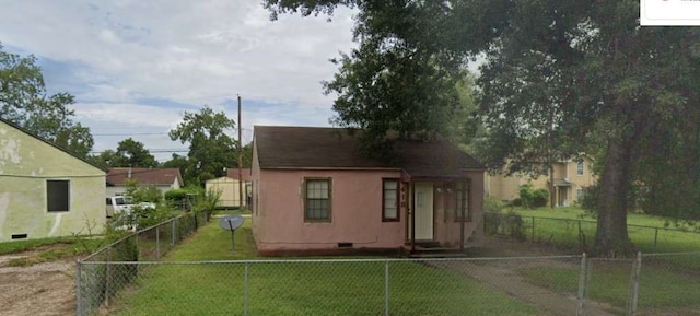 rear view of property featuring a yard