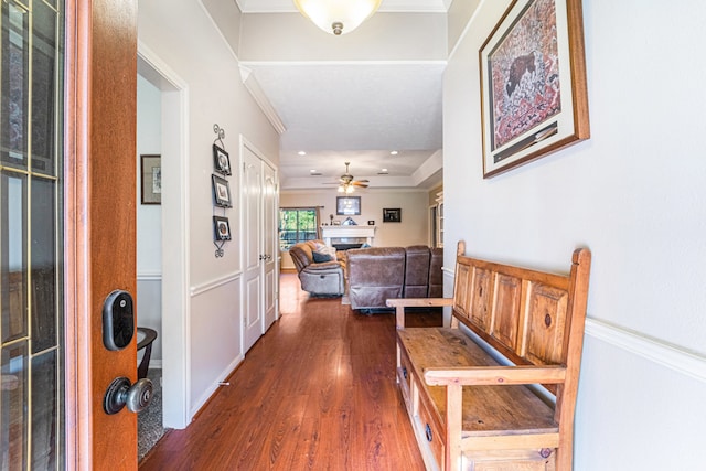 corridor featuring dark hardwood / wood-style flooring and crown molding