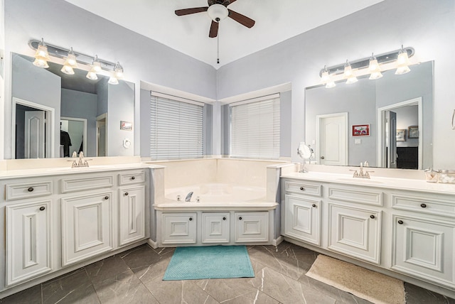 bathroom with a tub, ceiling fan, and vanity