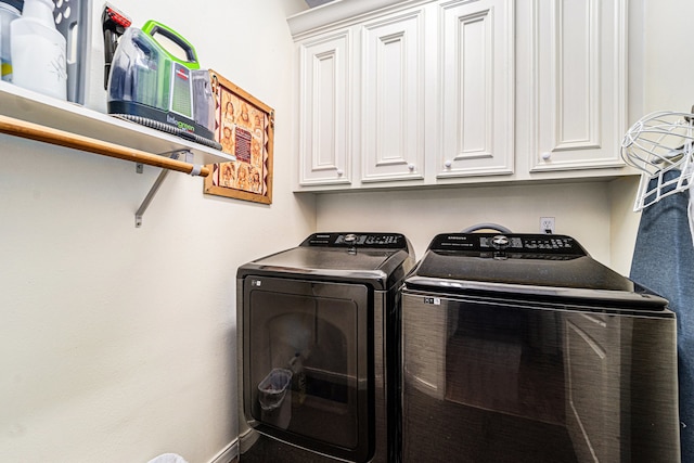 washroom featuring cabinets and separate washer and dryer