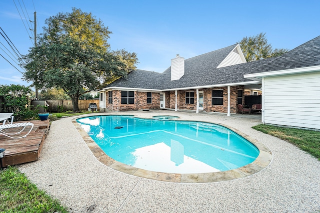 view of pool featuring a patio area and an in ground hot tub