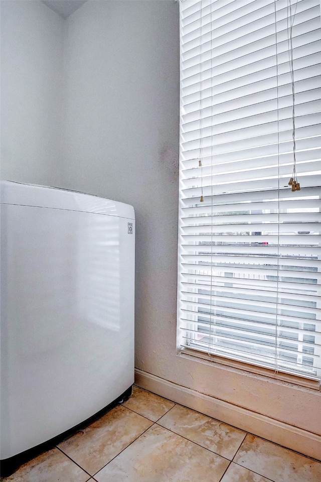 clothes washing area featuring light tile patterned flooring