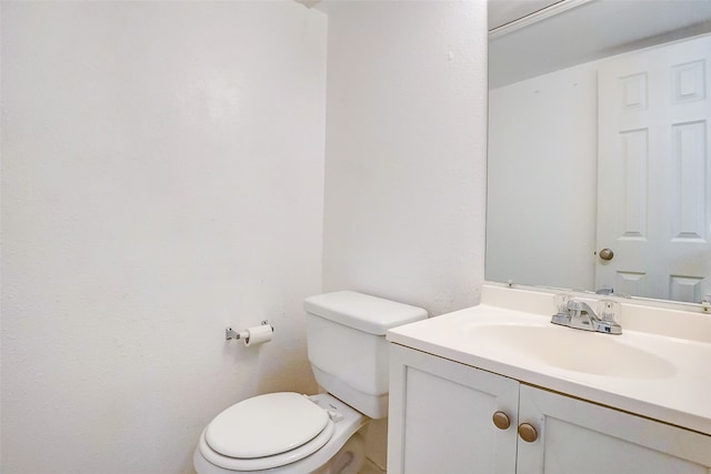 bathroom with toilet and vanity