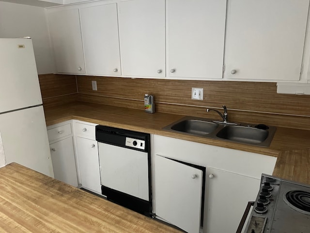 kitchen featuring white cabinets and white appliances