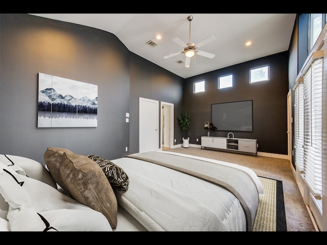 bedroom featuring multiple windows, high vaulted ceiling, carpet flooring, and ceiling fan