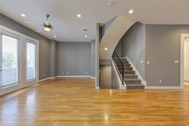 unfurnished living room with light hardwood / wood-style floors and ceiling fan