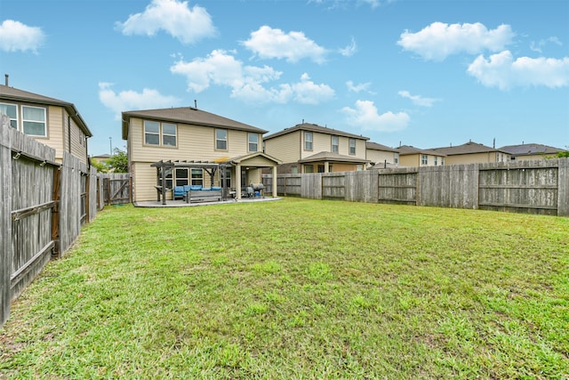 back of house featuring a patio and a yard