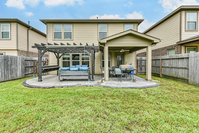 rear view of property featuring a patio area, a pergola, ceiling fan, outdoor lounge area, and a lawn