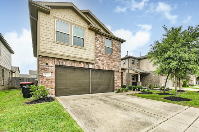 view of front of home with a front yard and a garage